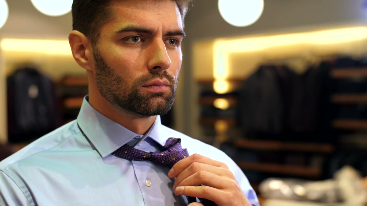 Man tying a tie